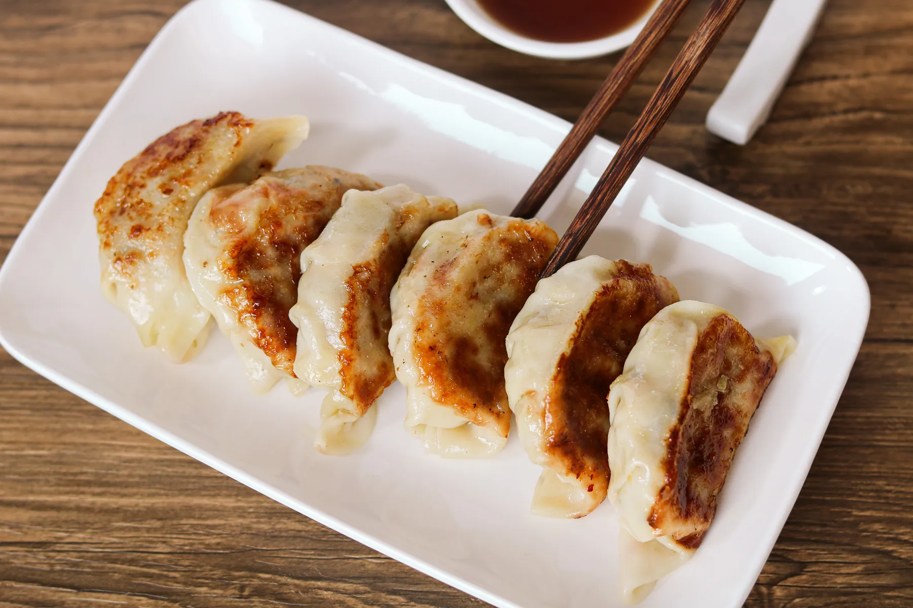 Pan-seared Japanese gyoza served with dipping sauce
