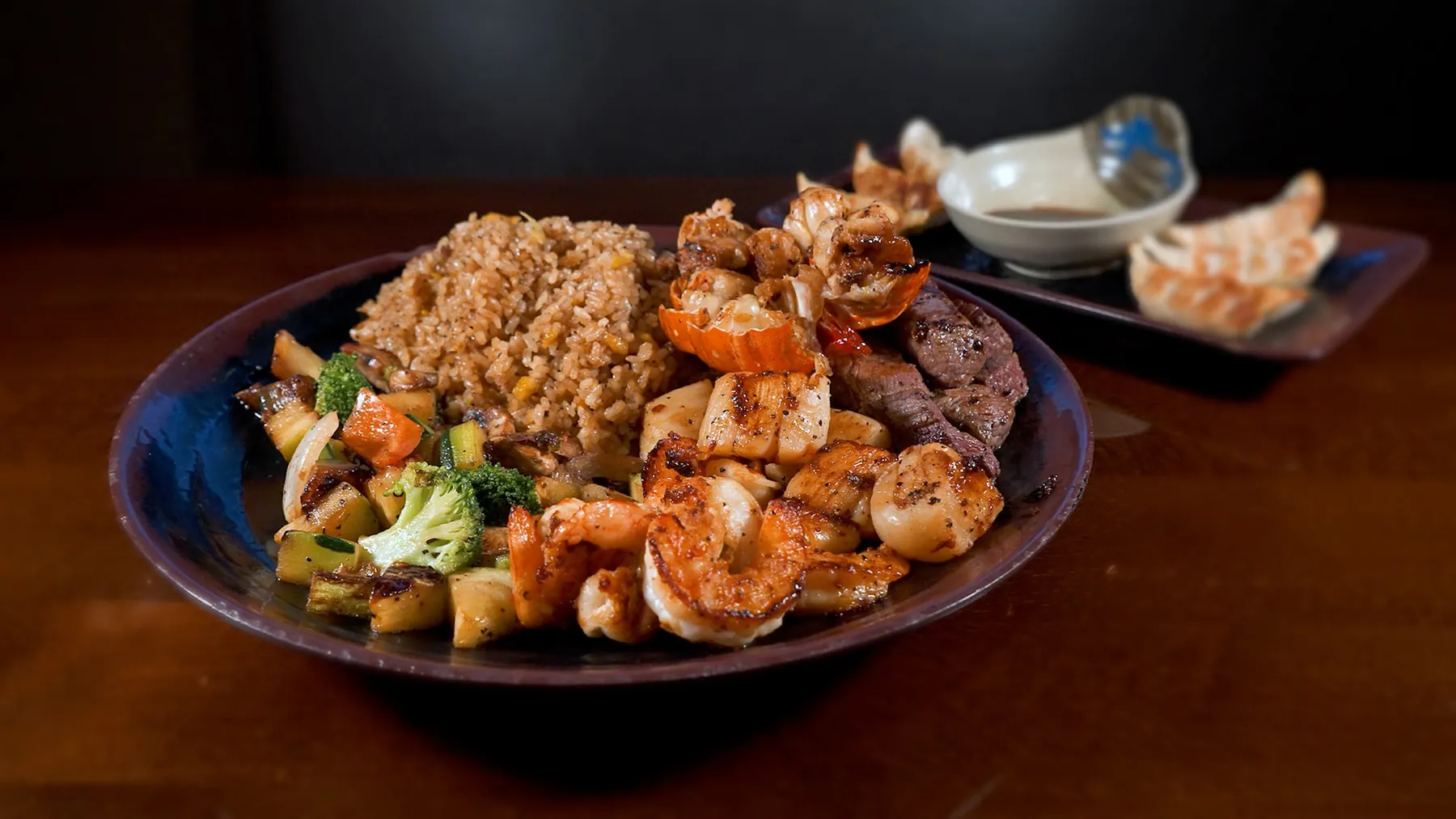 Hibachi steak, shrimp, scallops, vegetables, and fried rice