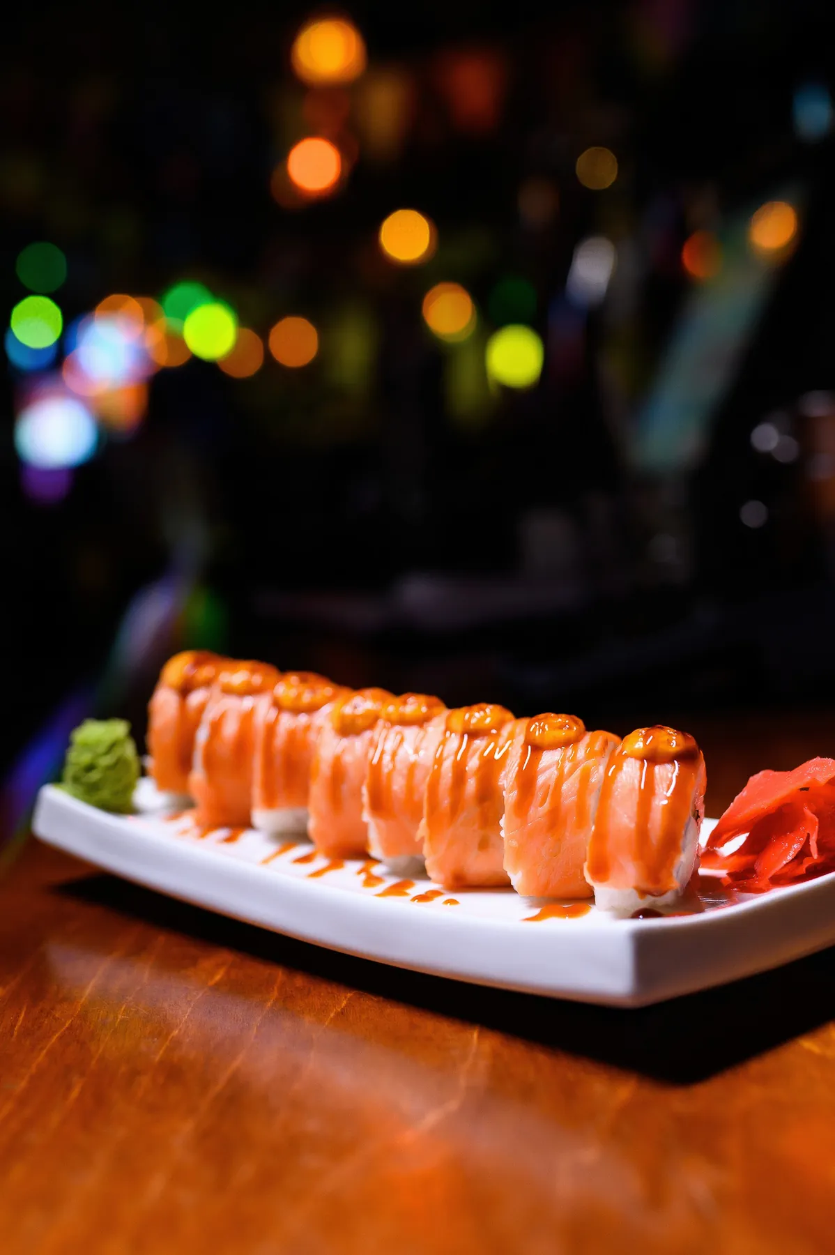 Salmon sushi roll finished with sauce